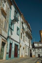 Alley of old colorful houses with worn plaster wall