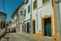 Alley of old colorful houses with worn plaster wall