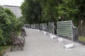 Alley in a park with benches and fencing repairs Royalty Free Stock Photo