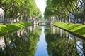 Alley and river in the city, green trees. TOURISM AND TRAVEL. Copy space Royalty Free Stock Photo