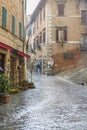 Alley with running water and a heavy rain