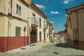 Alley in slope with traffic signs and old buildings at Caceres