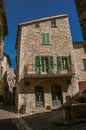 Alley with square, stone houses and fountain in Saint-Paul-de-Vence. Royalty Free Stock Photo