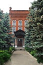 Alley with tall fur trees leading to old red brick house in Yele Royalty Free Stock Photo