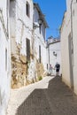 Alley with tourist couple strolling in Ronda Spain