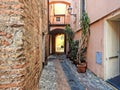 A typical Ligurian alley Italy called `caruggio` with flower pots.