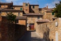 Alley with typical stone houses, San Quirico d`Orcia, Tuscany, Italy Royalty Free Stock Photo