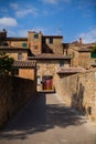 Alley with typical stone houses, San Quirico d`Orcia, Tuscany, Italy Royalty Free Stock Photo