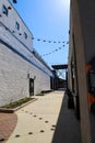 An alley way between two buildings with black lights hanging from black wires draped along the alley in Atlanta Royalty Free Stock Photo