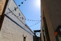 An alley way between two buildings with black lights hanging from black wires draped along the alley in Atlanta Royalty Free Stock Photo