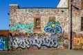 Alley-way wall covered with graffiti in Montreal borough of Hochelaga Maisonneuve Royalty Free Stock Photo