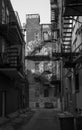 Alleyway with graffiti and fire escapes