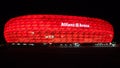 Allianz Arena illuminated at night.