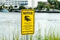 Alligator warning sign notice near water