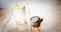 Alloa, Scotland - 17 July 2019 - watch and glass of water isolated on a wooden table. Accurist man watch