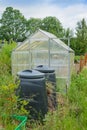 Allotment garden green house with compost bins