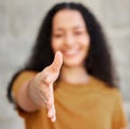 Allow me to introduce myself. a young woman extending her hand for a handshake.