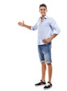 Allow me to introduce your copyspace. Full body portrait of a handsome young man gesturing towards copyspace. Royalty Free Stock Photo