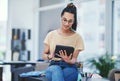 Allow technology to assist in easing your workload. a young designer using a digital tablet in an office. Royalty Free Stock Photo