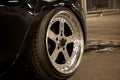 Alloy polished rims of a sports car. Wide wheels with stretched tires. Tuned low car