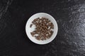 Allspice in a bowl on a slate