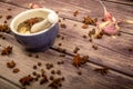 Allspice in a ceramic mortar and scattered garlic cloves, star anise and allspice on a wooden table. Close up Royalty Free Stock Photo