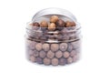 Allspice dry seeds in transparent plastic jar Royalty Free Stock Photo