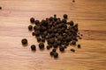 Allspice on a wooden background. View from above. Seasoning flavoring for meat and food.