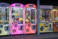 the alluring array of colorful claw machines testing your skills to snag prizes with crane-attached claws in the penny arcade