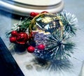 Alluring Christmas ornament decoration. Close up photo of gold ball decorated with red balls and new year tree branch Royalty Free Stock Photo