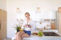 Alluring girl holds phone and reads information on Internet, sit Royalty Free Stock Photo