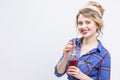 Alluring and Happy Caucasian Blond Girl Posing in Checked Shirt and Headband Drinking Juice Royalty Free Stock Photo