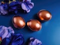 Golden Easter Eggs and Elegant Iris Flowers on a Dark blue background Royalty Free Stock Photo