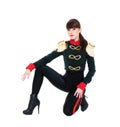 Alluring model in stage costume sitting