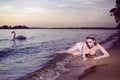 Alluring Sensual Sea Mermaid Blond Woman With Artistic Makeup and Strasses on Face Posing on Ocean Waves with Silver Crown And Net