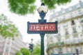 Alma Marceau Paris metro sign with trees and buildings in the background