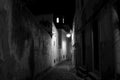 Almada at night. Black and white street photo. BW. Dark streetphoto. Old Europe. Historic building. Lantern. Sityscape.