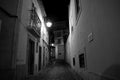 Almada at night. Black and white street photo. BW. Dark streetphoto. Old Europe. Historic building. Lantern. Sityscape.