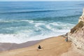 Almagreira Beach with surfer and fisherman waiting for Atlantic chances in Ferrel, Peniche, central western Coast of Portugal Royalty Free Stock Photo