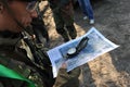 Almaty, Kazakhstan - 06.29.2013 : The airsoft player looks at the location of the posts on the map