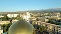 Almaty, Kazakhstan - August 17, 2023: The central dome of the mosque with a crescent moon in the background of the city