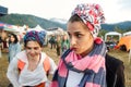 Two happy young woman at the Ethno festival Foure in the ethno clothers, walk and talk