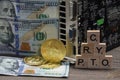 Almaty, Kazakhstan - 04.04.2023 : The bitcoin coin is on the table next to the dollars, the inscription: crypto and a video card