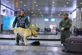 Almaty, Kazakhstan - 10.08.2015 : Border patrol officers with a dog check luggage at the airport