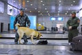 Almaty, Kazakhstan - 10.08.2015 : Border patrol officers with a dog check luggage at the airport