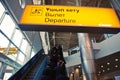 Almaty, Kazakhstan - 10.08.2015 : A bright sign with the inscription: departure on the background of the escalator at the airport