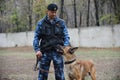 Almaty, Kazakhstan - 11.04.2014 : A dog handler prepares for training with a service dog