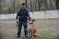 Almaty, Kazakhstan - 11.04.2014 : A dog handler prepares for training with a service dog