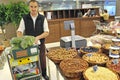 Almaty, Kazakhstan - 11.07.2012 : An employee of a large hypermarket puts vegetables in sections Royalty Free Stock Photo