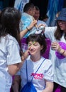 ALMATY, KAZAKHSTAN - JUNE 10, 2018: Unidentified girl makeup artist makes a bright carnival face painting to the